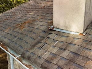 Image of a visibly sagging roof line, suggesting underlying structural damage such as weakened rafters or water saturation.