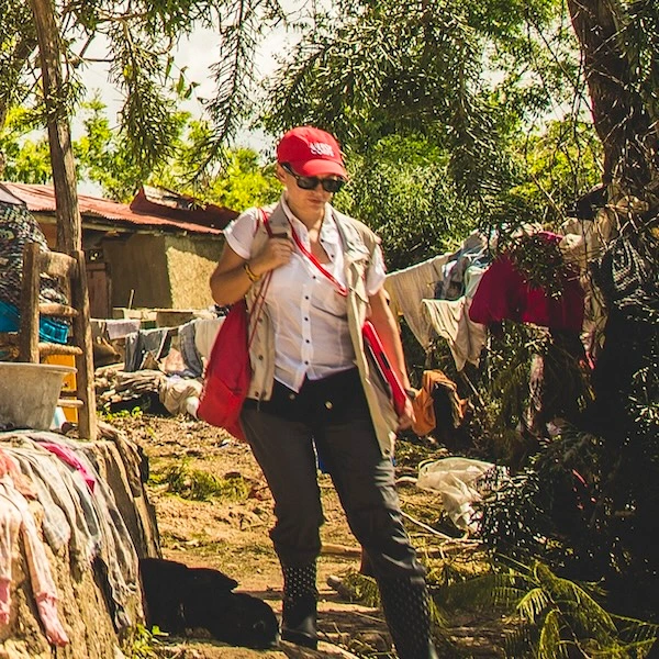 Jasmine Avgerakis-Marks walking through a rural area in Haiti, involved in disaster recovery efforts after Hurricane Matthew.