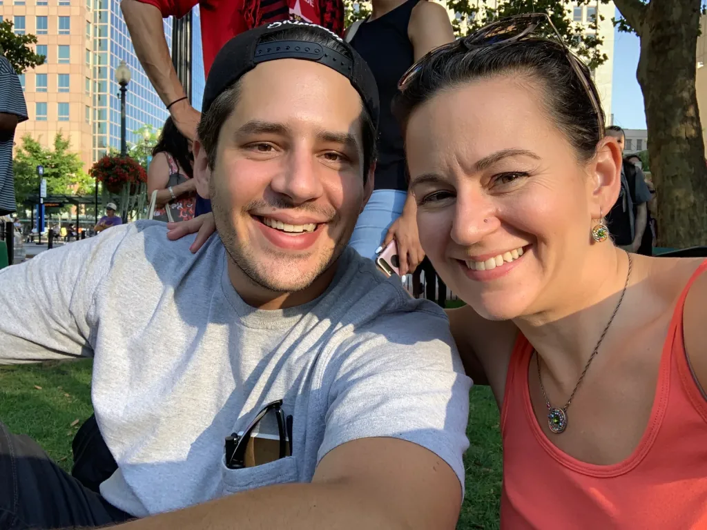 Ethan and Jasmine, siblings and co-founders of Choose Your Own Roofing, smiling together at a community event.