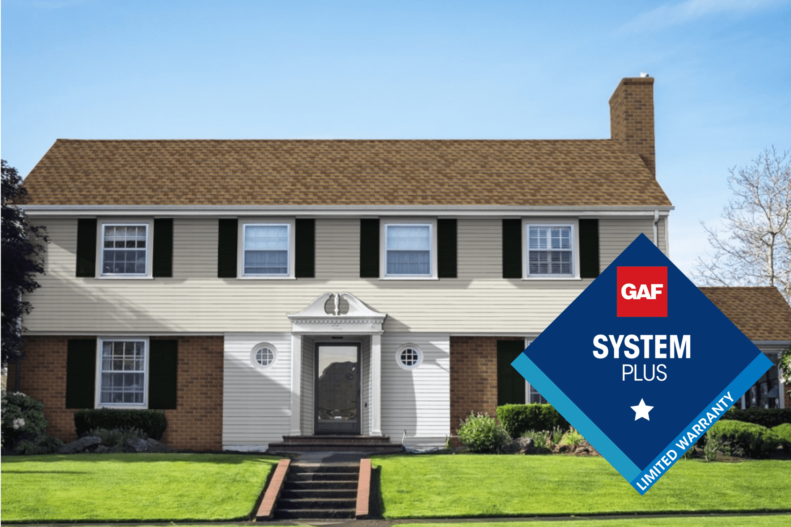 Front view of a two-story house with a new Timberline HDZ shingle roof and GAF System Plus Limited Warranty badge.